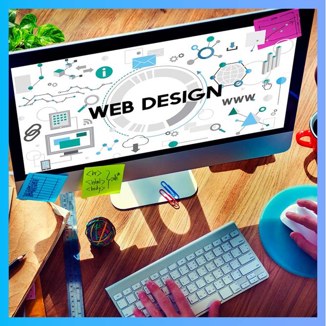 A computer workstation with a monitor displaying a Web Design interface featuring various graphics and icons A keyboard mouse and office supplies are also visible